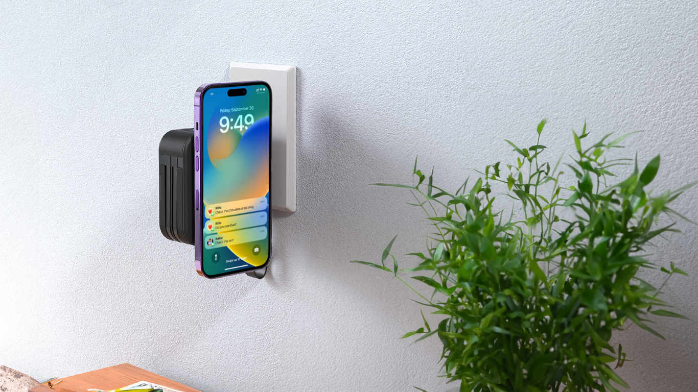 Travelcharge magnetic charger plugged into a wall outlet charging an iphone